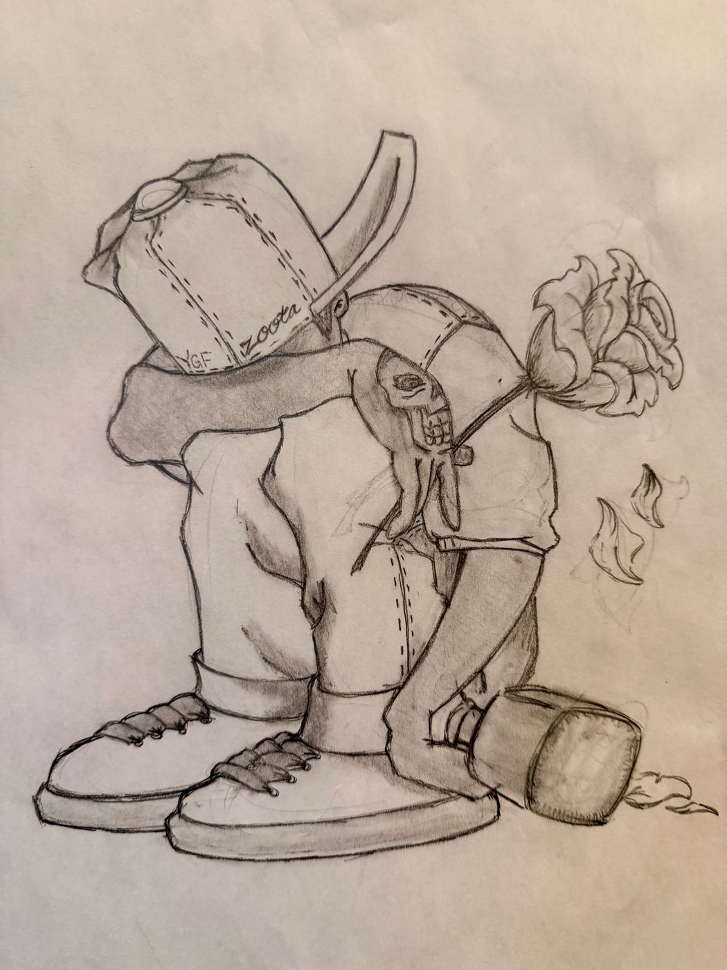 A graphite study of a figure crouched over, drawn from above, with carefully rendered sneakers