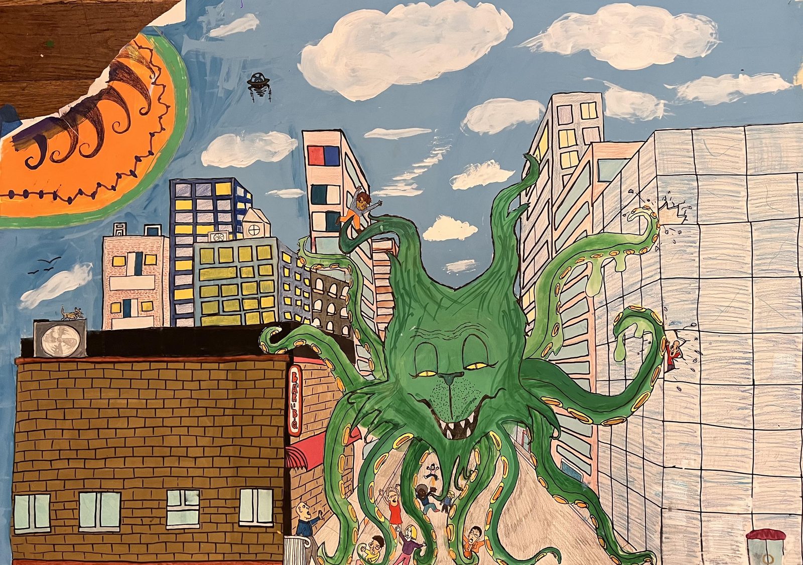 A green tentacled creature rising between city buildings under a blue sky